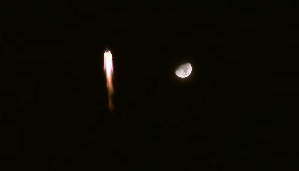 A Long March 2F carrying Shenzhou-13 rising against the backdrop of the moon on Oct. 15, 2021.