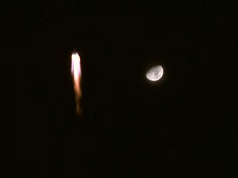 A Long March 2F carrying Shenzhou-13 rising against the backdrop of the moon on Oct. 15, 2021.